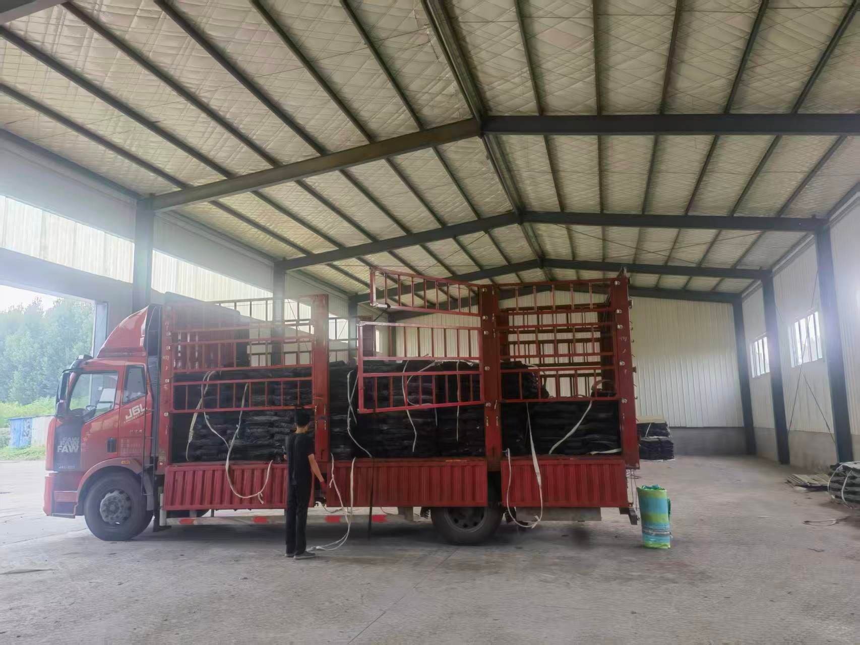 Finished reclaimed rubber sheets arranged in Xinyuan Rubber's workshop