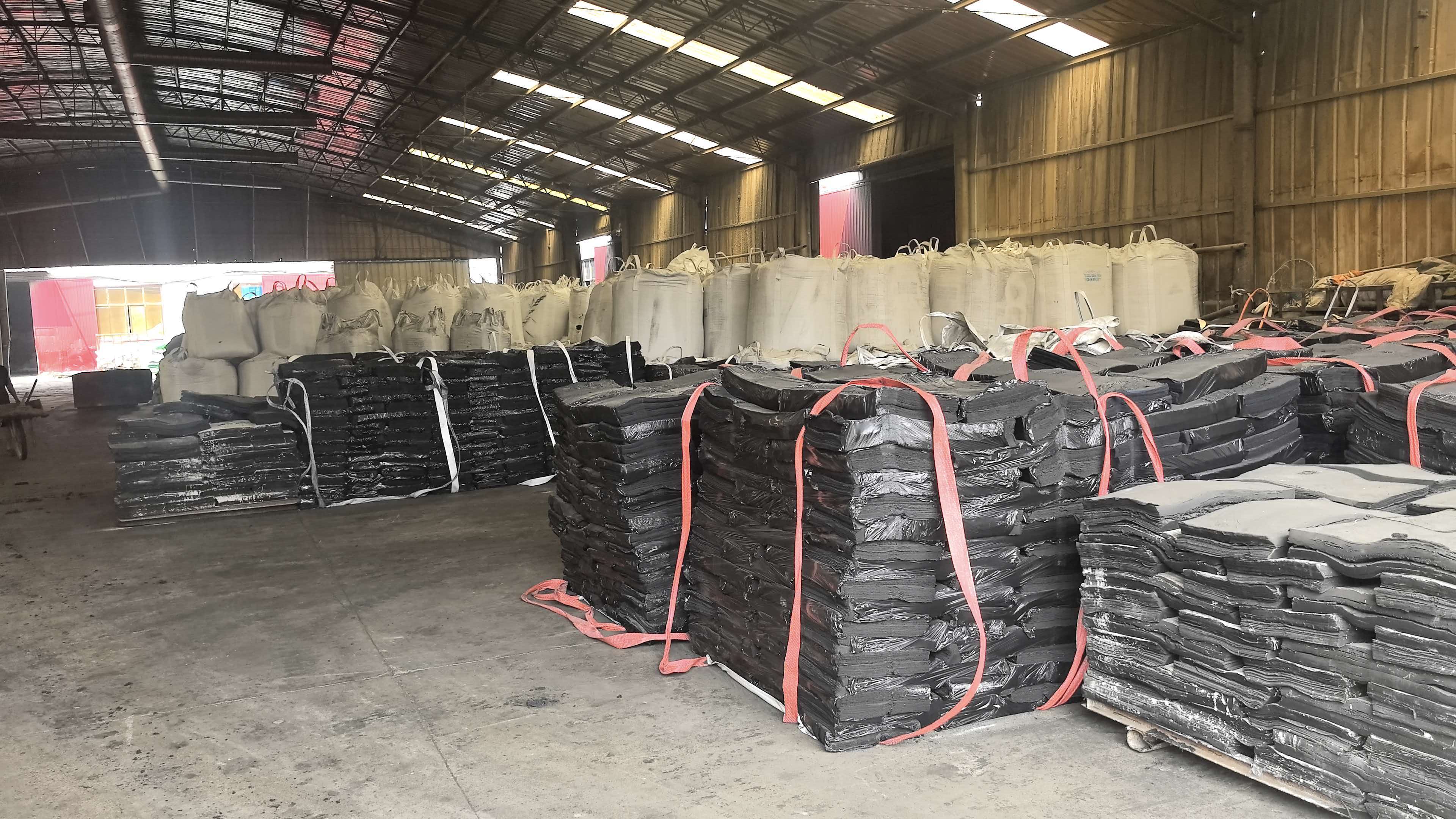 Refining and sheeting line with finished rubber sheets ready for weighing